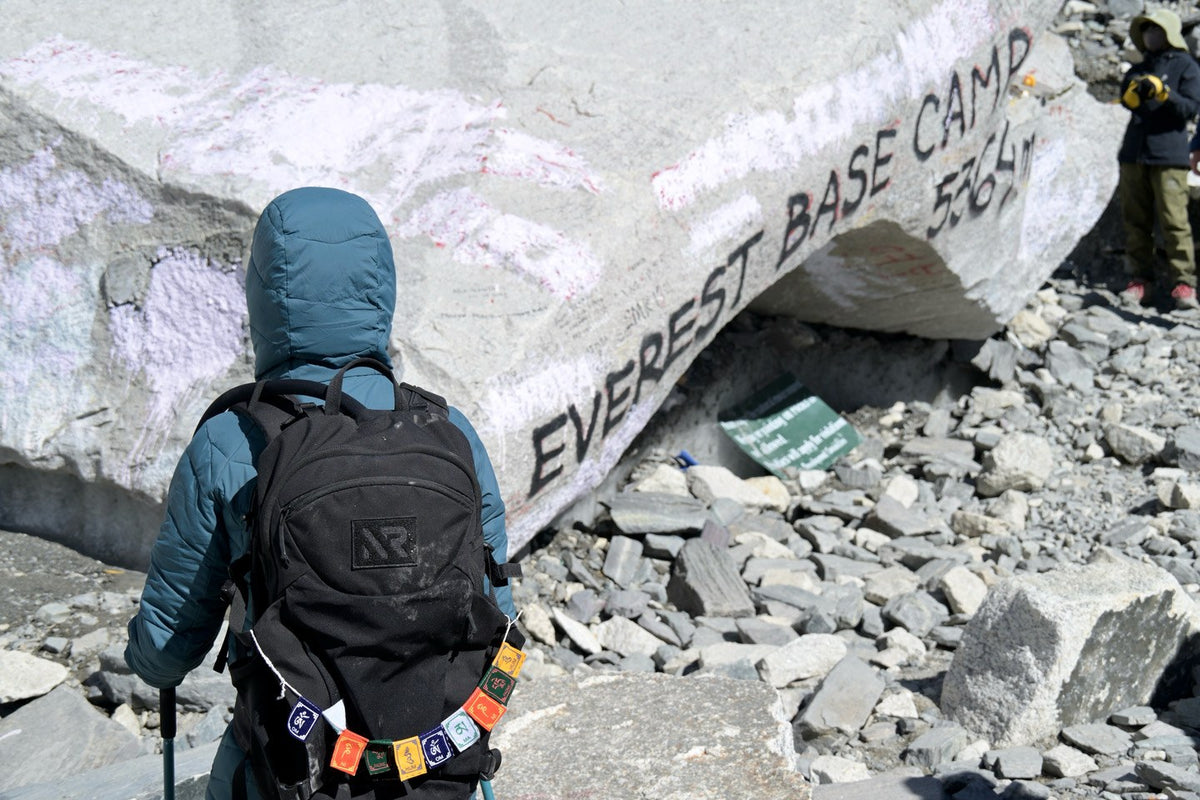 Raid Pack with prayer flags at the Everest Base Camp marker, 5,364 m