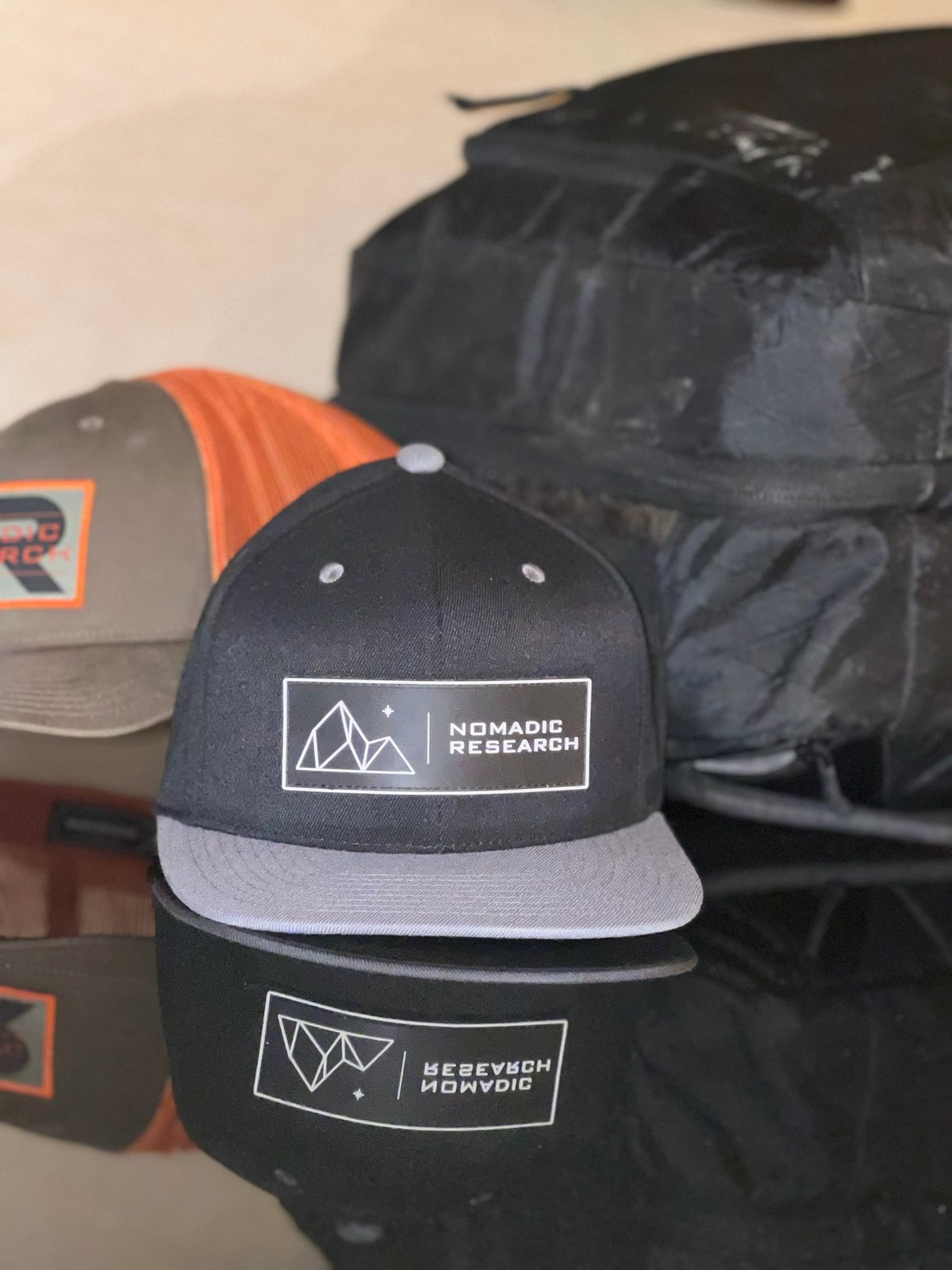 Mountain & Star Hat beside the orange patch trucker