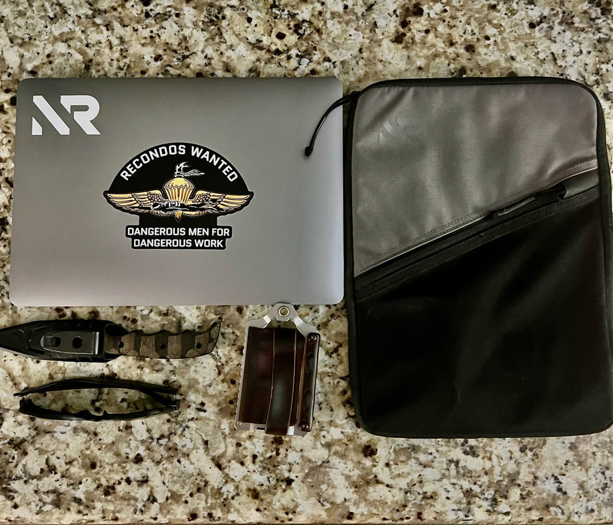 Laptop sleeve flat lay with laptop and daily carry